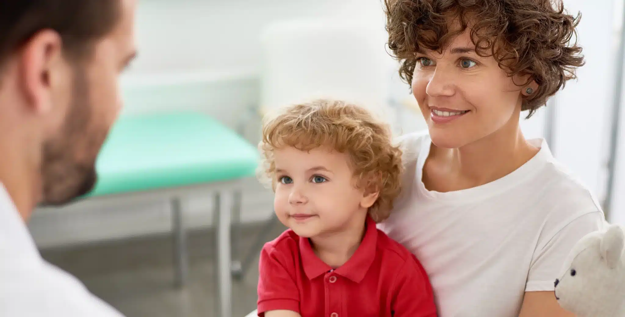 Parent and child consulting with a lice treatment professional at a clinic