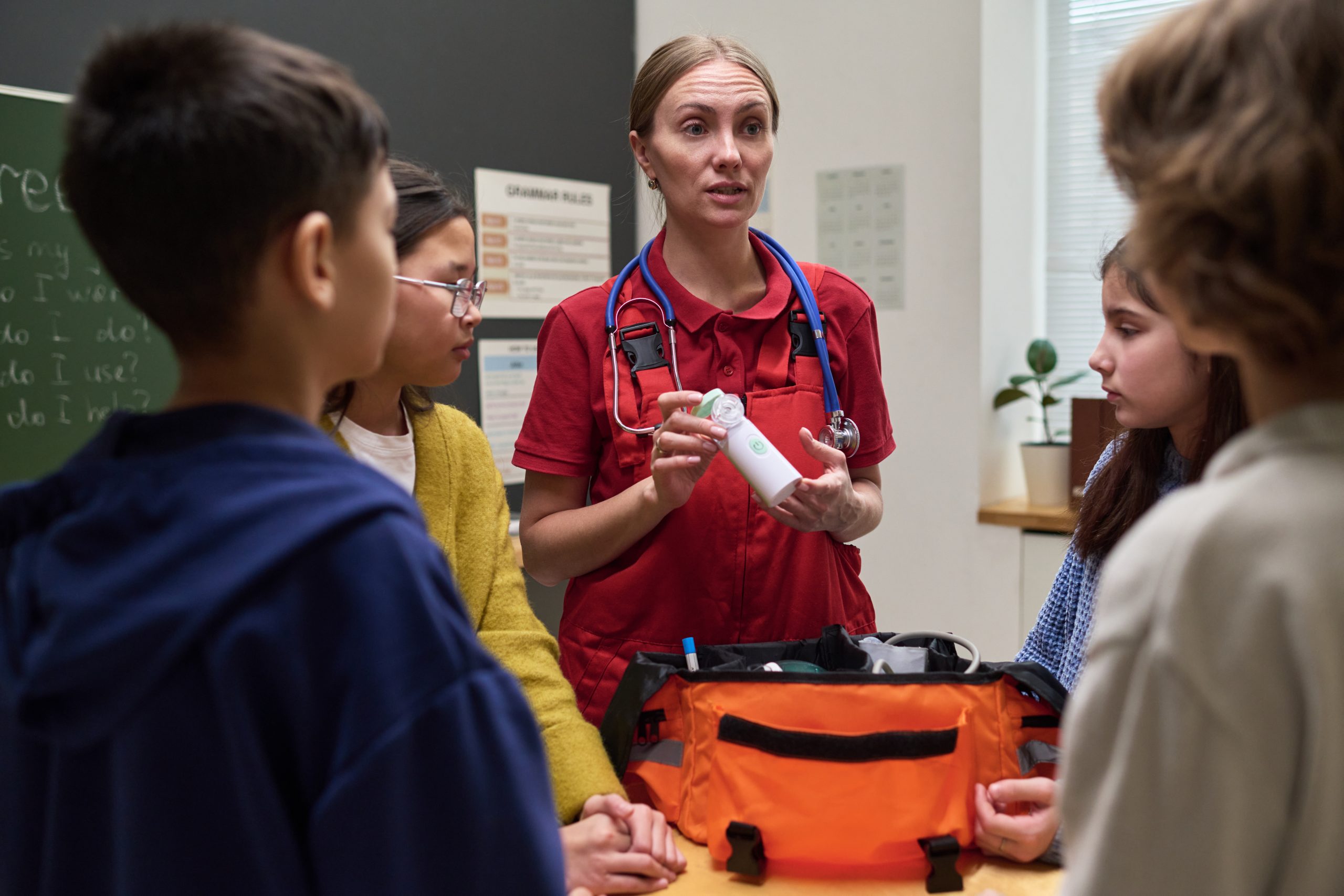 Health professional presenting to children in a classroom